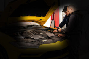 two-mechanics-stand-with-tbalet-against-open-hood-of-yellow-sport-car-suv-asap-motors-fourways-